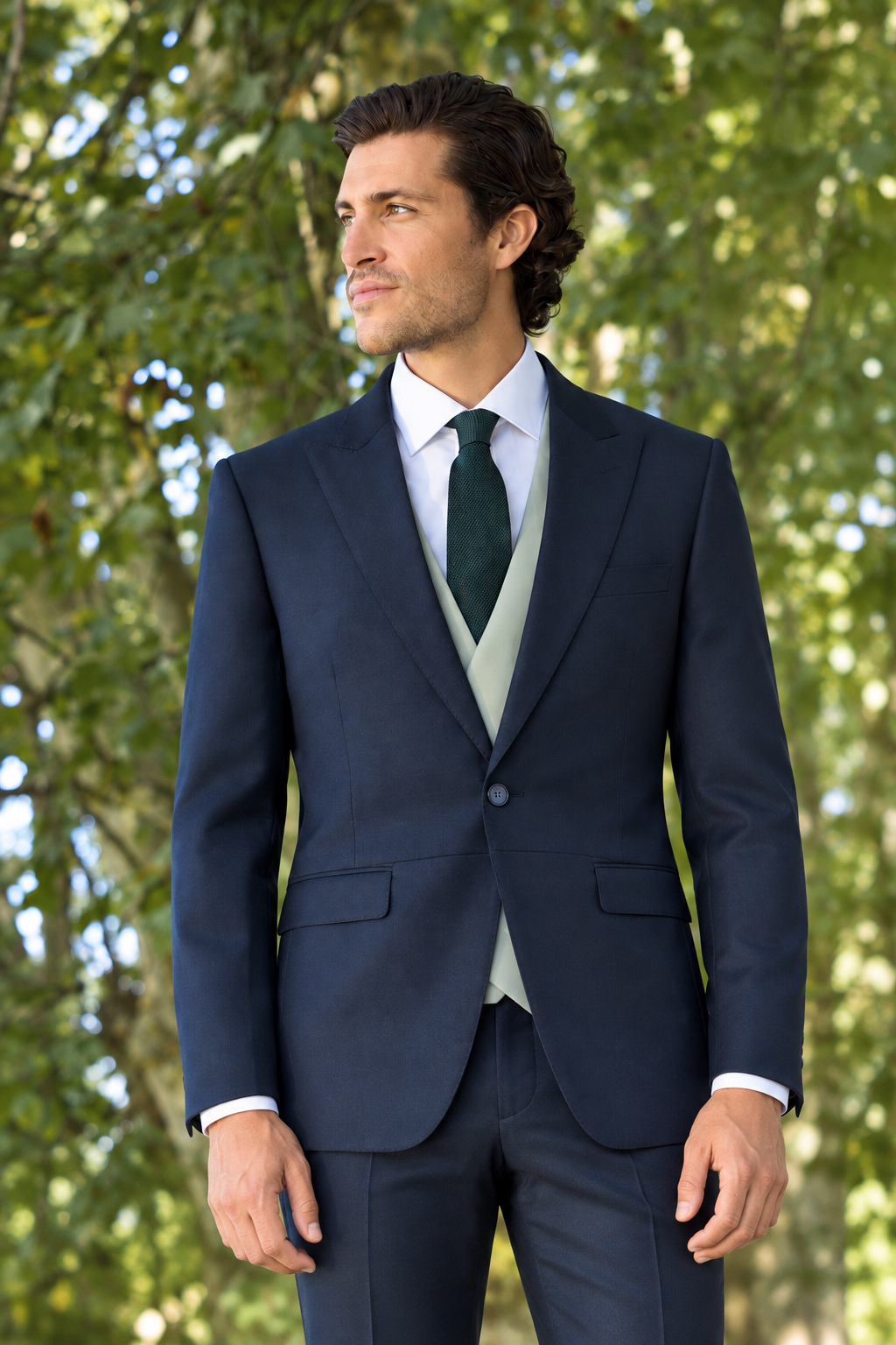 Traje oscuro con corbata verde y chaleco salvia de la nueva colección
